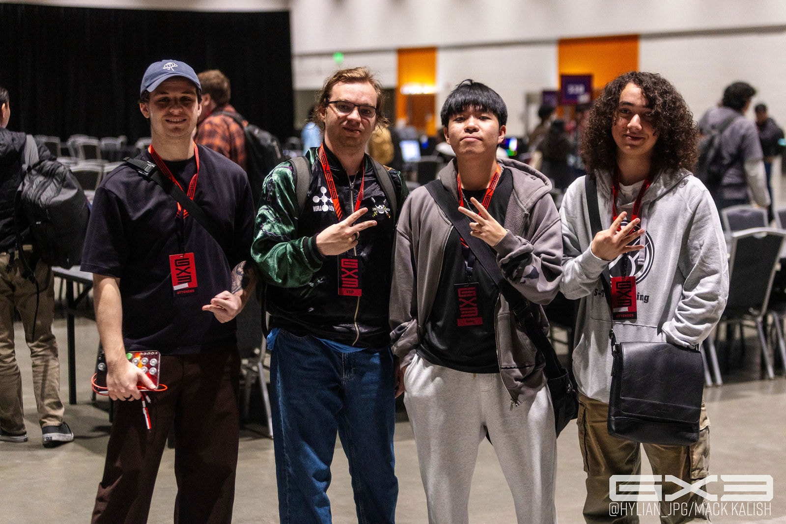 Four attendees pose together on the GENESIS X3 tournament floor
