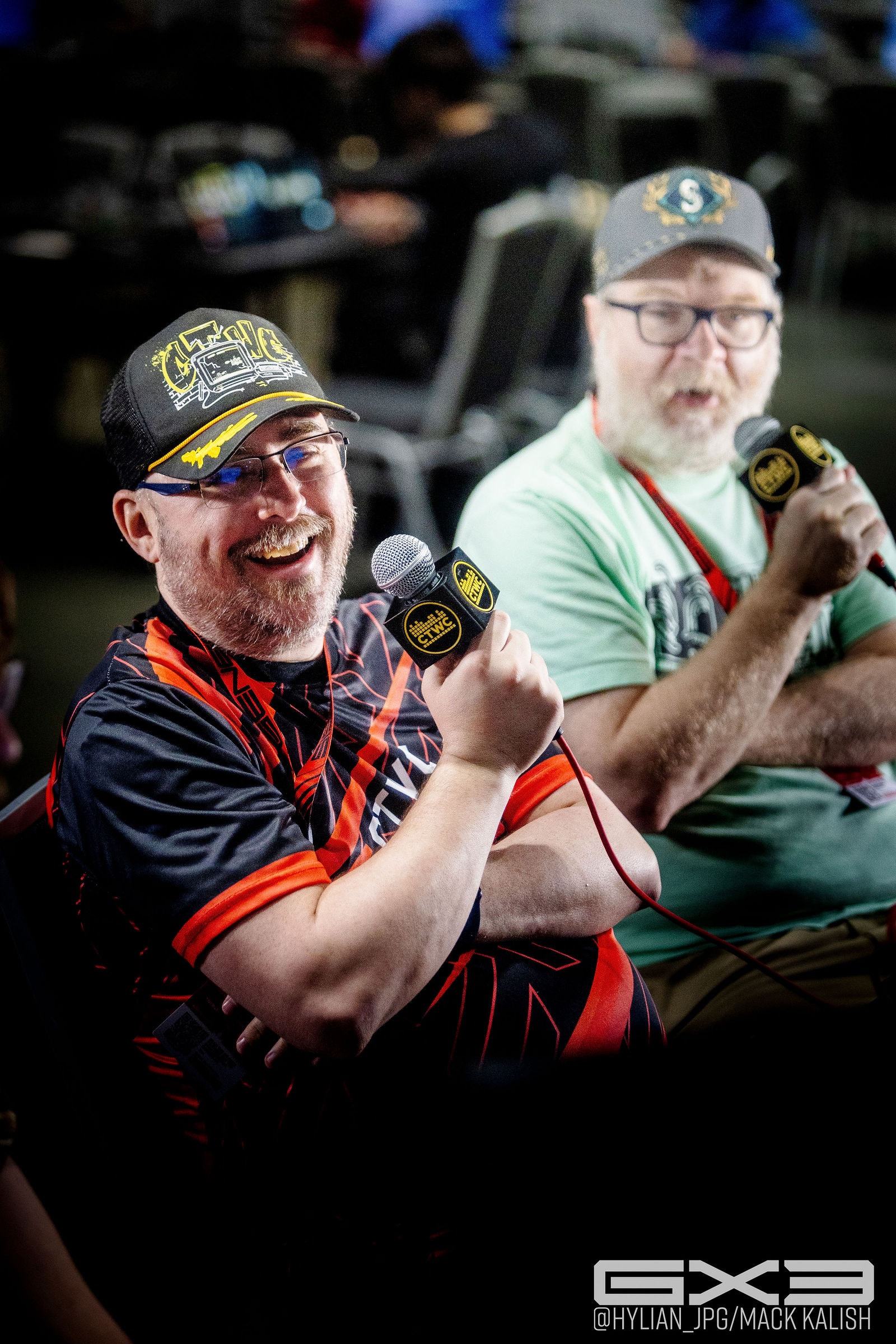 Two smiling attendees display their medals at GENESIS X3