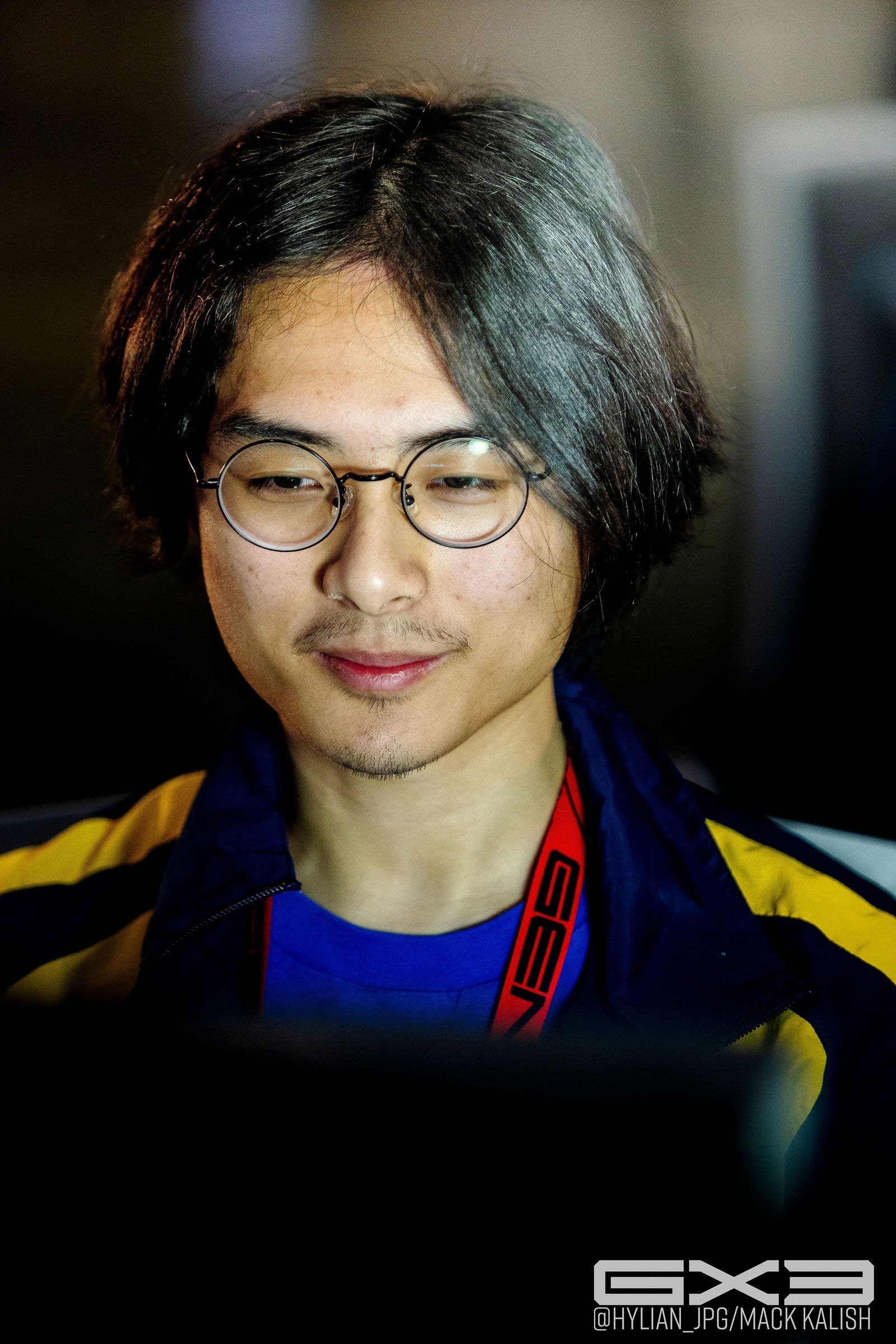 A competitor in glasses and a blue-and-yellow jersey at GENESIS X3